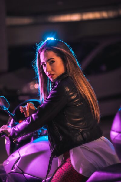 Portrait of a young blonde Caucasian model wearing a black leather jacket